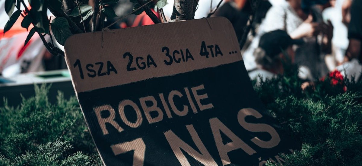 a sign in front of a crowd