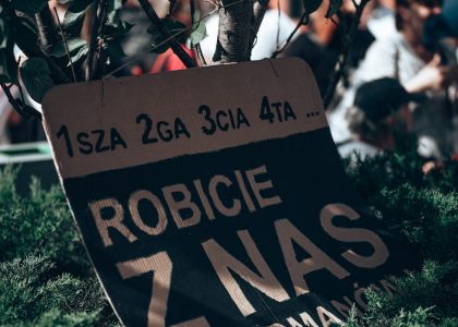 a sign in front of a crowd